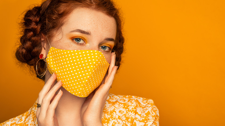 Trendy woman posing with mask