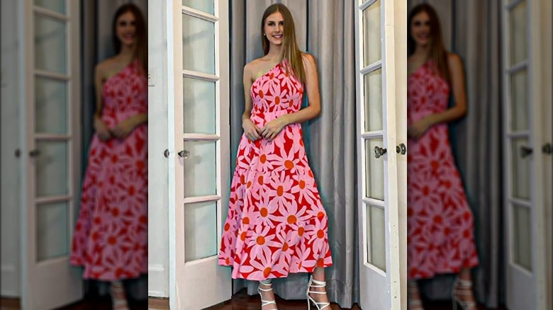 Woman wearing a pink one-shoulder floral dress