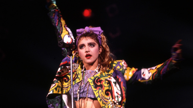 Young Madonna in a graphic print purple outfit on stage