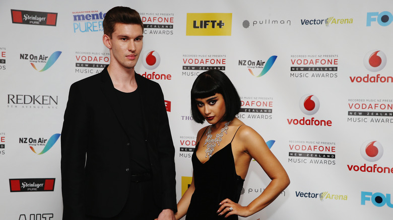 Natalia Kills and Willy Moon posing on step-and-repeat in 2014