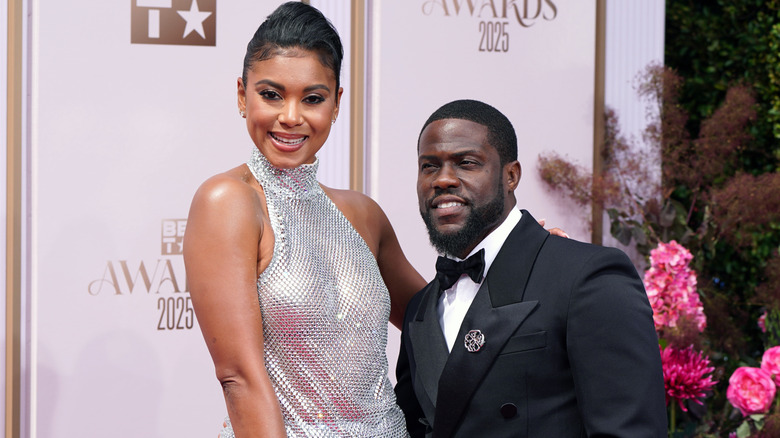 Eniko and Kevin Hart posing on a red carpet in 2025