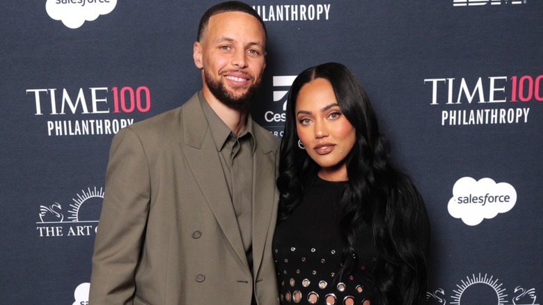 Stephen and Ayesha Curry posing together at a Time 100 event