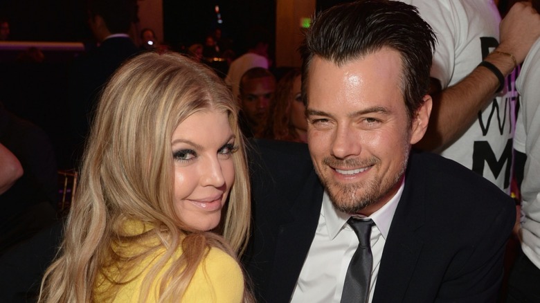 Fergie and Josh Duhamel sitting at a table and smiling.