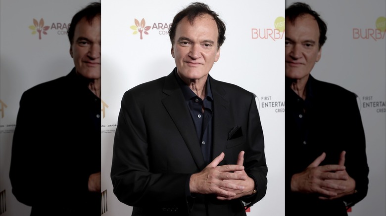 Quentin Tarantino dressed in all black on the red carpet.