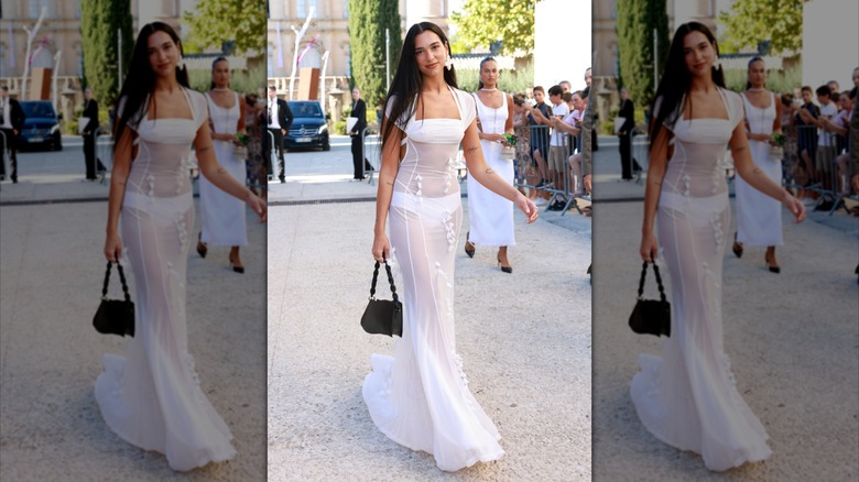 Dua Lipa walking in a white dress