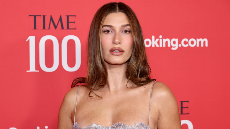 Hailey Bieber poses in a lacy dress