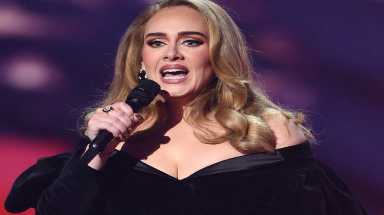 Adele holding a mic at an awards show