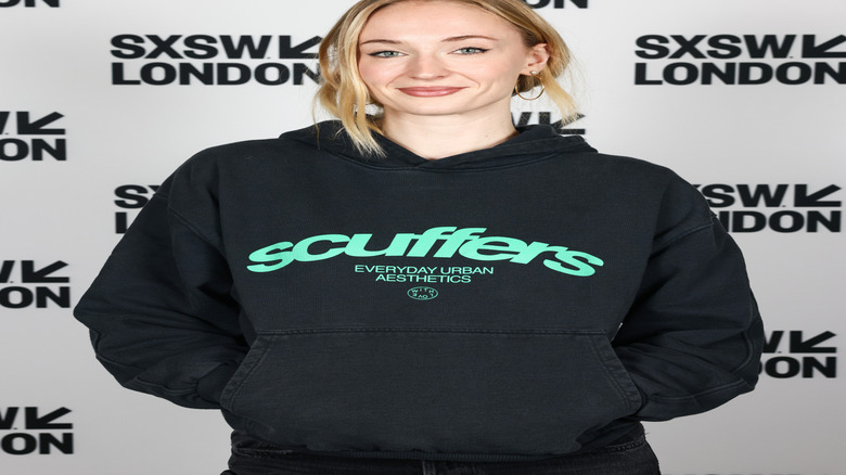 Sophie Turner smiling at a London event in 2025