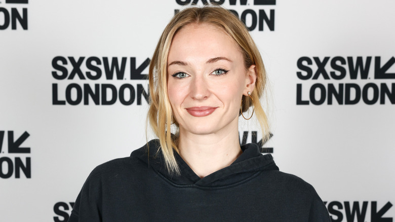 Sophie Turner smiling at a London event in 2025