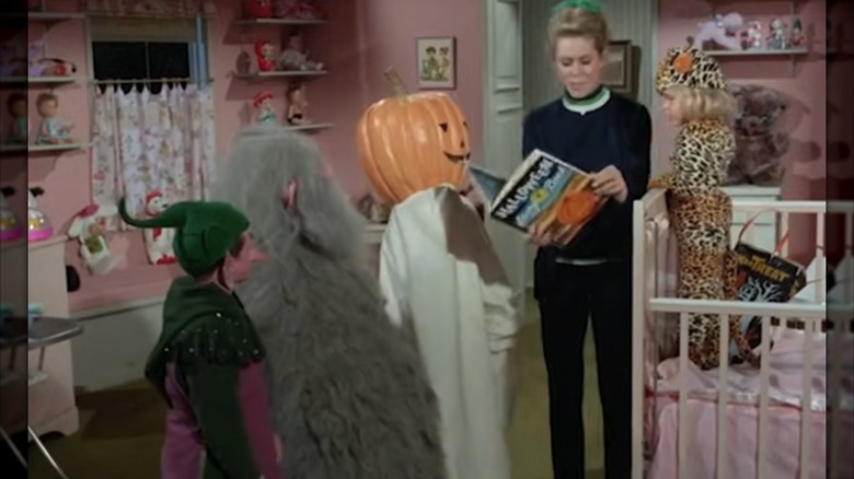 Elizabeth Montgomery and Erin Murphy with cast members dressed as monsters in Bewitched