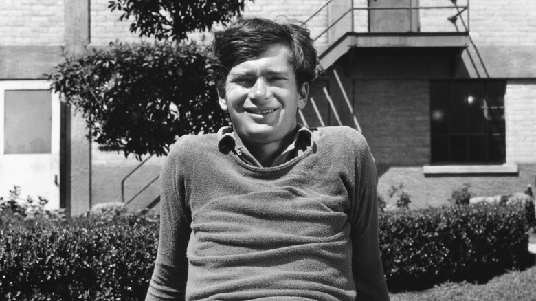 A young Buddy Ebsen smiling in a garden