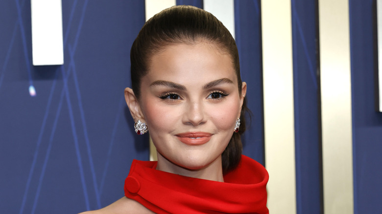 Selena Gomez in red with slicked back hair at the 2025 Emmy Awards