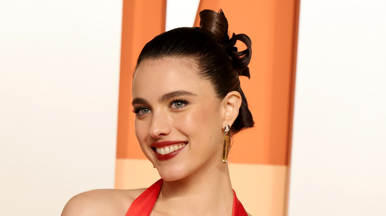 Margaret Qualley in red dress with sculpted updo at the 2025 Vanity Fair Oscars Party
