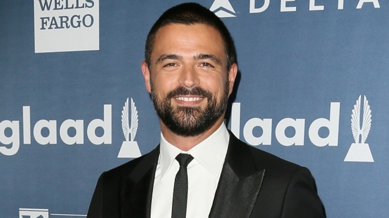 John Gidding smiling on step-and-repeat