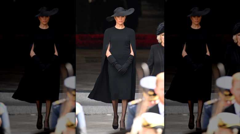 Meghan Markle walking in black outfit at Queen Elizabeth II's funeral