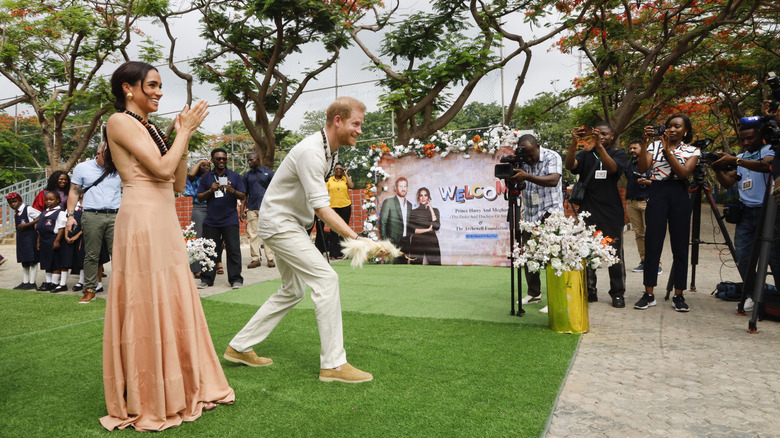 Meghan Makle clapping as Prince Harry plays game on Nigerian visit