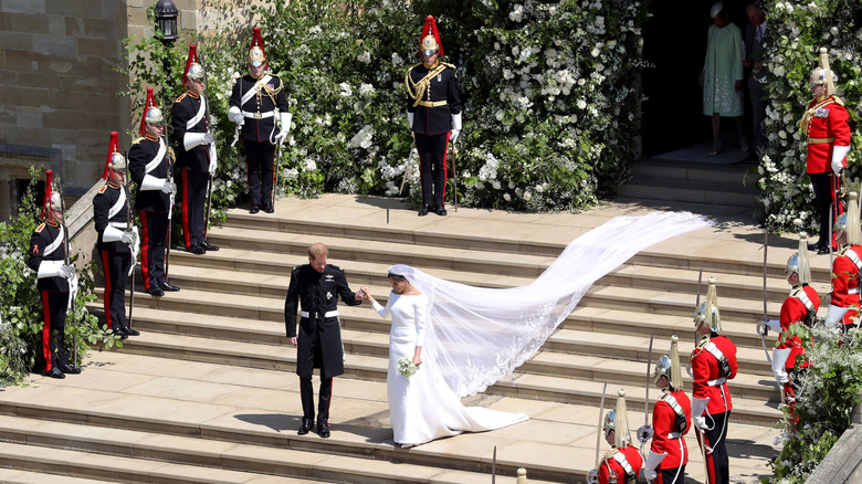 View from a height of Prince Harry and Meghan Markle leaving the chapel on their wedding day surrounded by royal guards