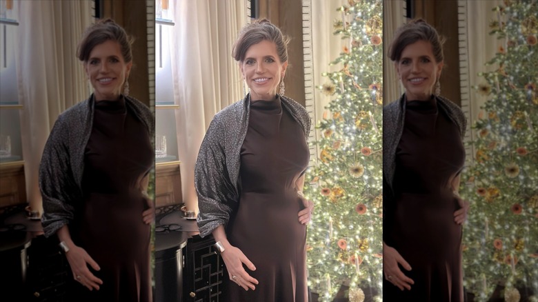 Nancy Mace with her hair pulled up, dress in a brown dress, in front of a Christmas tree.