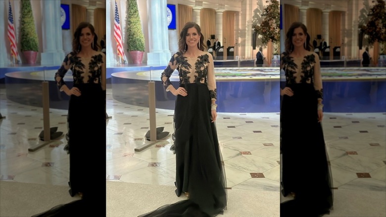 Nancy Mace in a black lace dress with her hand on her hip.