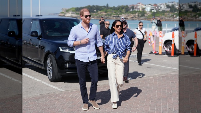 Prince Harry and Meghan Markle exiting a car at Bondi Beach