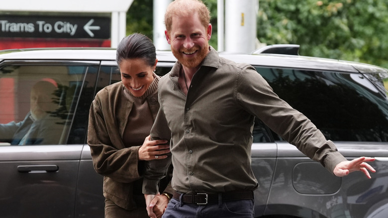 Prince Harry and Meghan Markle exiting a car