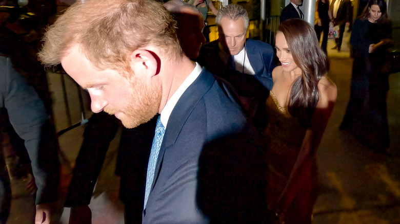 Prince Harry and Meghan Markle escorted by security