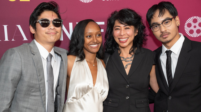 Maddox, Zahara, Pax Jolie-Pitt and guest smiling at the screening of "Maria" in 2024