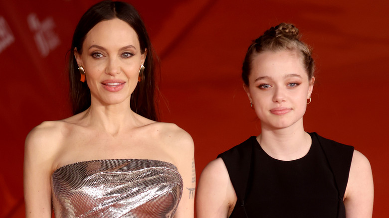 Angelina Jolie and Shiloh Jolie-Pitt smiling on the red carpet of "Eternals" in 2021