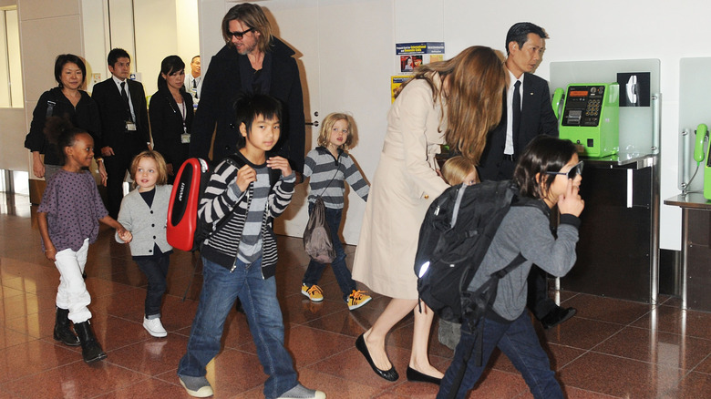 Brad Pitt, Angelina Jolie, Maddox, Zahara, Shiloh, Pax, Vivienne, and Knox Jolie-Pitt walking at the Haneda International Airport