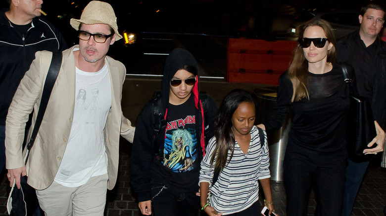 Brad Pitt, Angelina Jolie, Maddox, and Zahara Jolie-Pitt walking at LAX in 2014