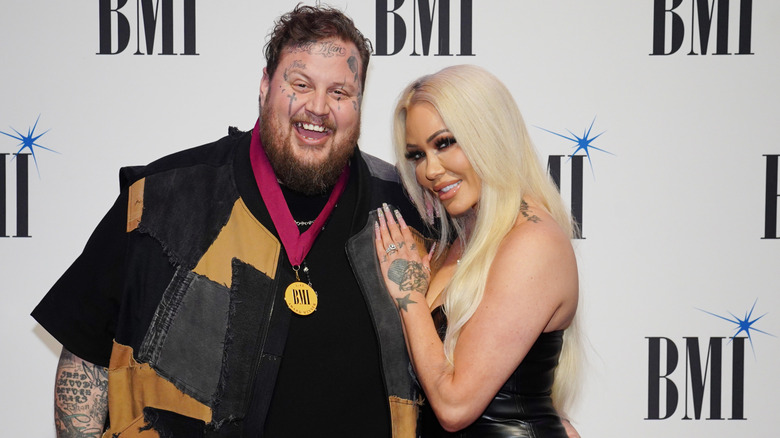 Jelly Roll and Bunnie Xo smiling at the BMI Country Awards in 2023