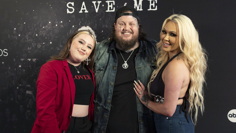 Jelly Roll, Bailee Ann DeFord and Bunnie Xo smiling at the "Jelly Roll: Save Me Documentary" premiere in 2024