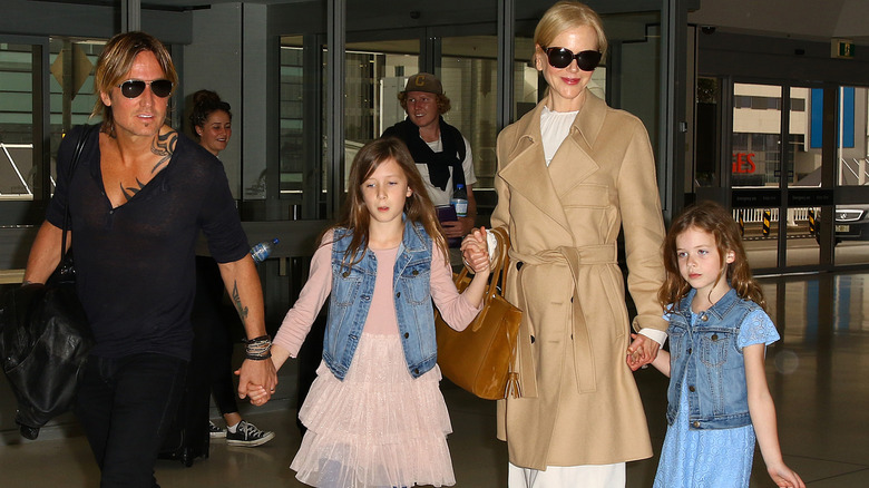 Keith Urban, Nicole Kidman, Sunday Rose, and Faith Margaret walking at the Sydney Airport