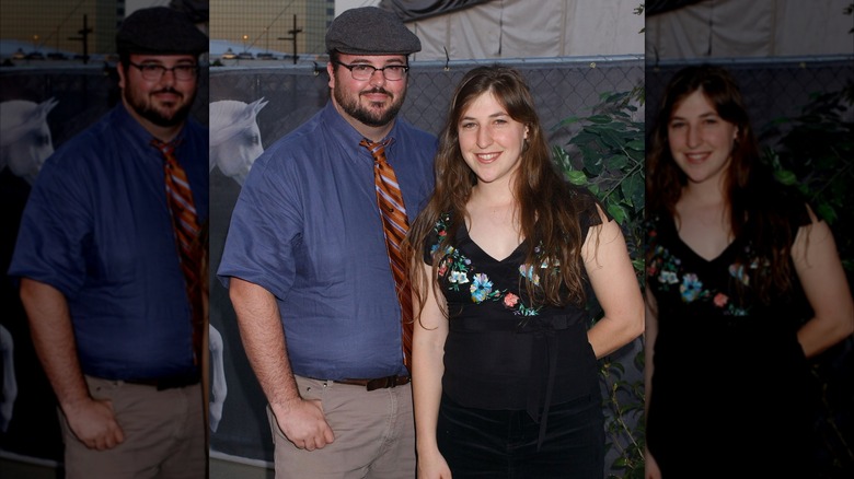 Mayim Bialik wearing black dress and posing beside ex-husband Michael Stone