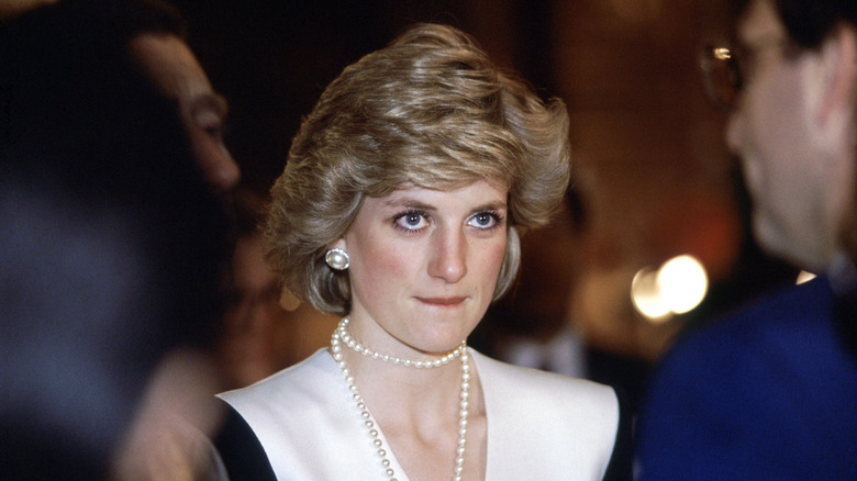 Princess Diana biting her lip in a double stringed pearl necklace