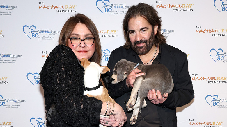 Rachael Ray and John Cusimano holding dogs at the North Shore Animal League America's Celebration of Rescue in 2024