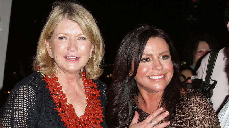 Rachael Ray and Martha Stewart smiling at the South Beach Wine and Food Festival in 2011
