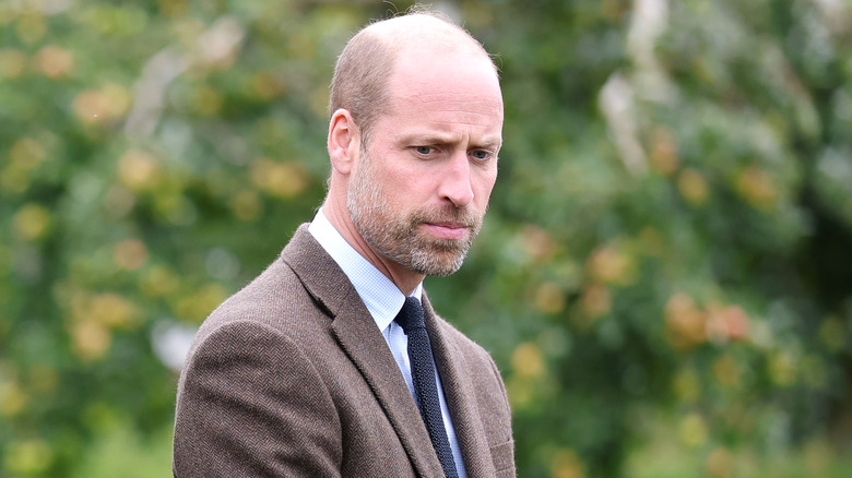 Prince William looking down in a serious way