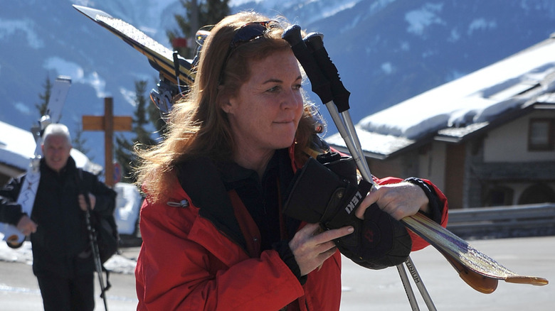 Sarah Ferguson carrying skis in Switzerland