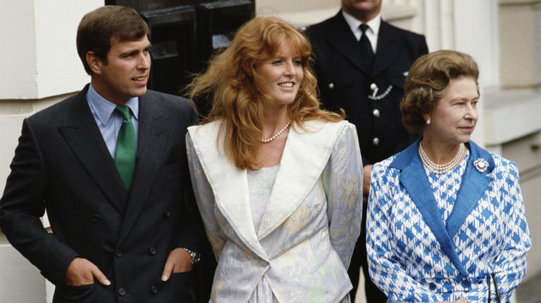 Prince Andrew, Sarah Ferguson, and Queen Elizabeth II standing side-by-side