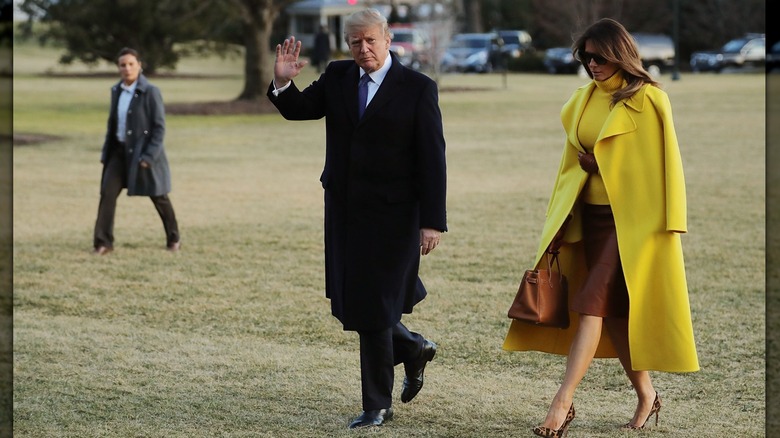 Donald and Melania Trump walk across the South Lawn in February 2018