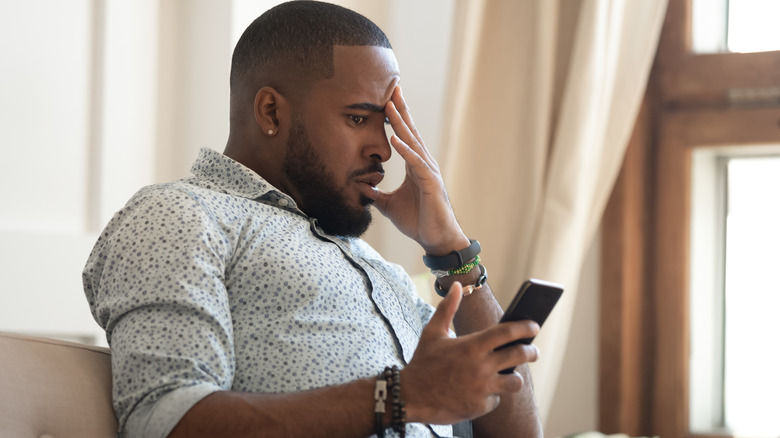 Man looking surprised at his phone