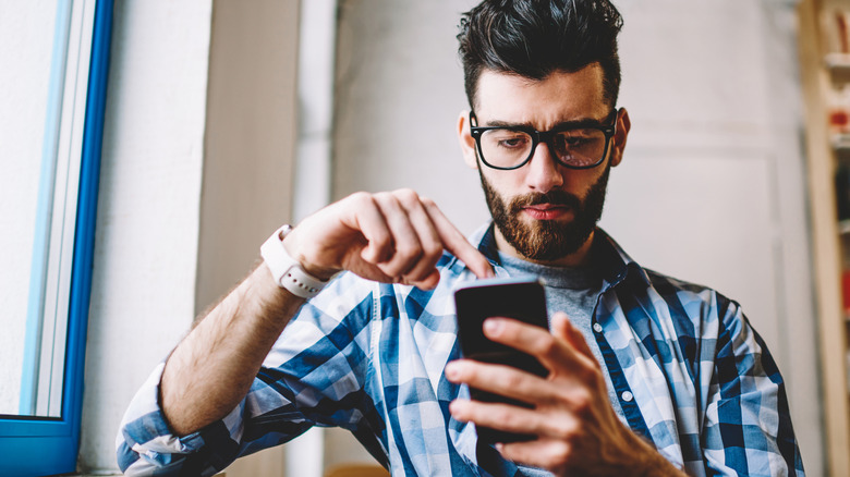 Man looking at phone screen