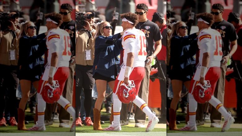 Brittany Mahomes on the side lines, pulling Patrick Mahomes near.