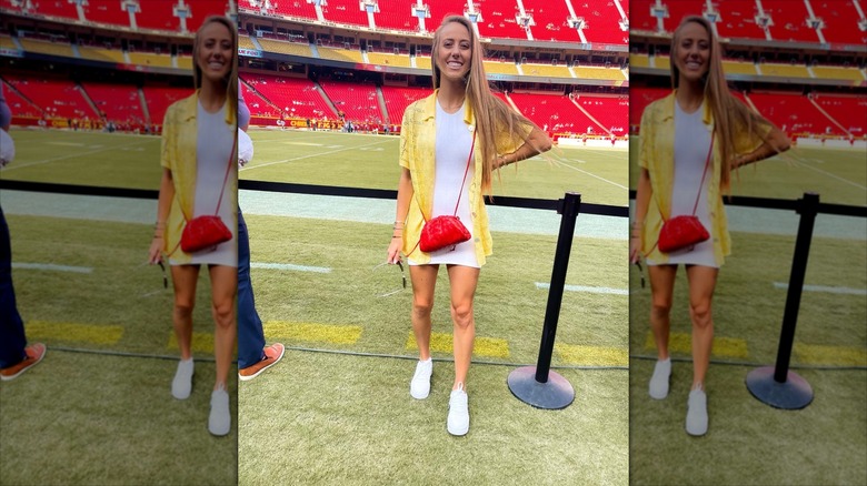 Brittany Mahomes with her hand on her hips, smiling.