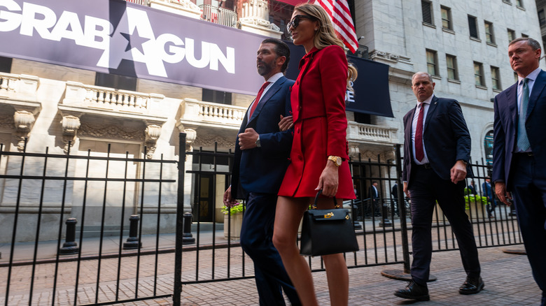Donald Trump Jr. and his girlfriend Bettina Anderson walk outside of the New York Stock Exchange (NYSE) after Trump rang the opening bell for the Texas-based firearm e-commerce platform GrabAGun where Trump is a member of the board on July 16, 2025 in New York City (2025)