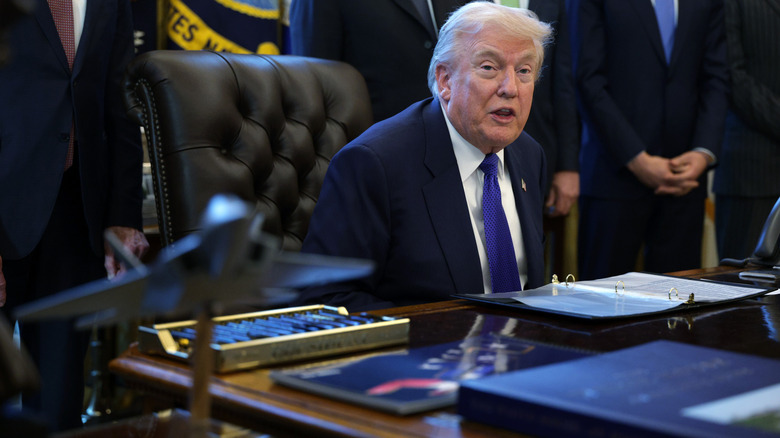 Donald Trump addressing someone from behind his desk