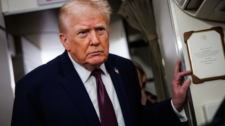 Donald Trump looking grouchy as he addresses reporters on Air Force One