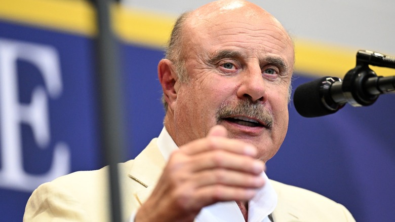 Dr. Phil speaking in front of a microphone
