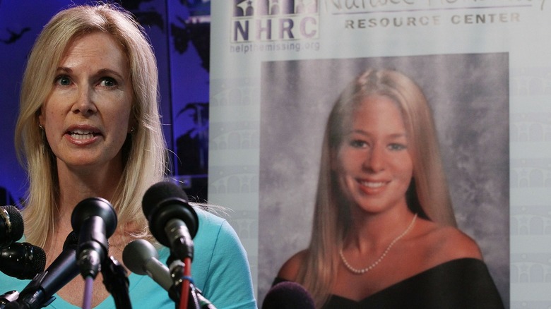 Beth Holloway speaking at the Natalee Holloway Resource Center (NHRC) 2010 launch, with a photo of Natalee in the background.